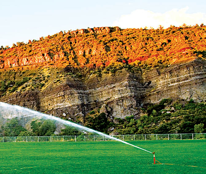 red cliffs with sprinkler sports field